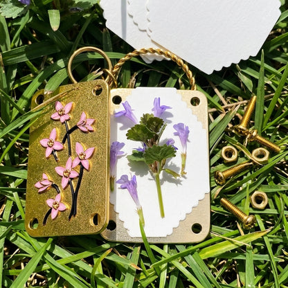 Bloomkept press opened with a pressed purple flower